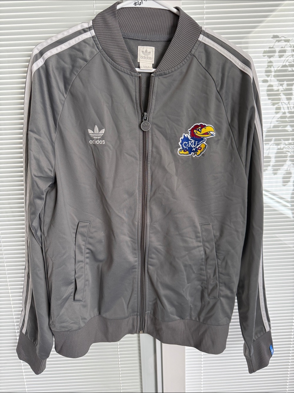 adidas Originals Gray Kansas Jayhawks Bomber Jacket with White Stripes.